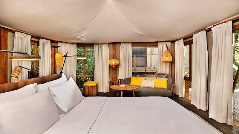 white and yellow bedroom decor,wooden bed ideas,latin american bedroom,kasiiya papagayo luxury eco retreat,natural materials bedroom,