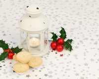 merry and bright Christmas,white lantern with candle,stars decor on holiday table,