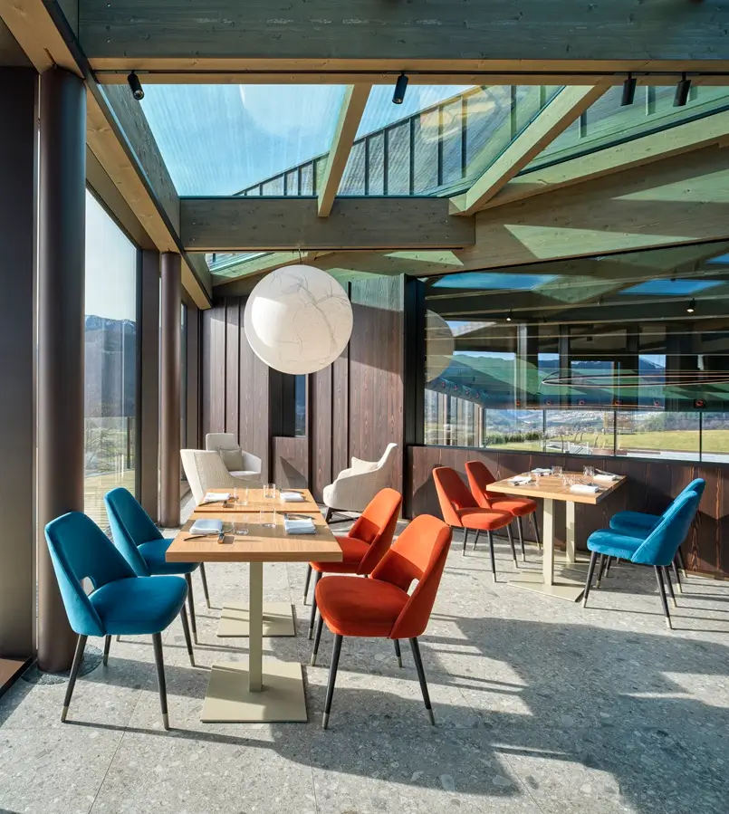 bar design with orange and blue chairs and large windows, archi-living.com