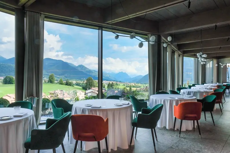 restaurant design with colorful chairs and large windows with a view of the mountains, archi-living.com