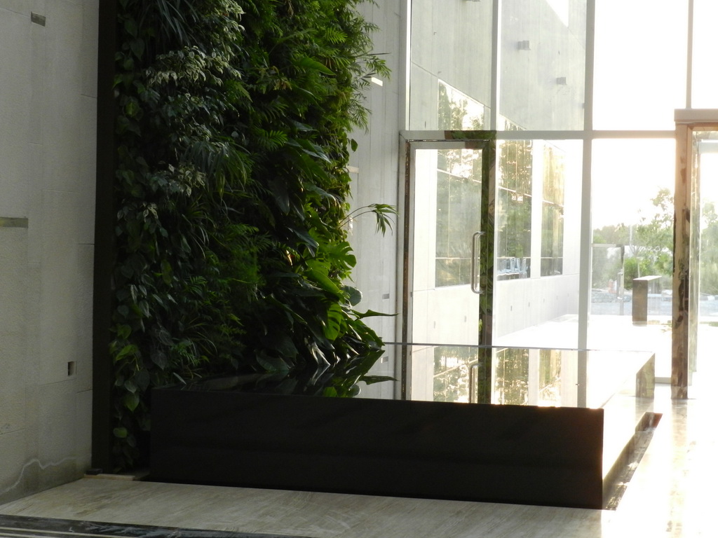 vertical garden in the lobby design,vertical garden above pool area,greenery and water in interior design,greenery in lobby ideas,golf club design ideas,