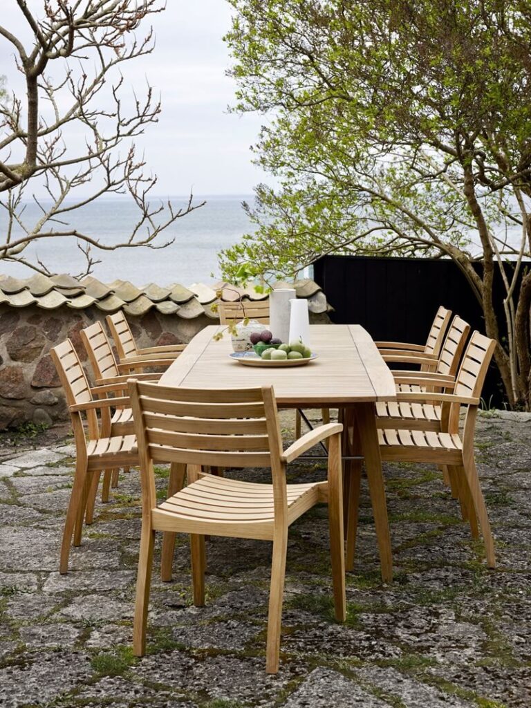 Stackable armrest chair and table BALLARE by Jakob Berg for Skagerak for the garden made of high-quality teak wood - classic Scandinavian design, Archi-living.com