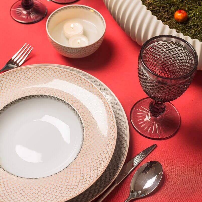 elegant dinnerware collection,porcelain plates holiday,red and pink table settings,red glasses for wine,Christmas plates and bowls,